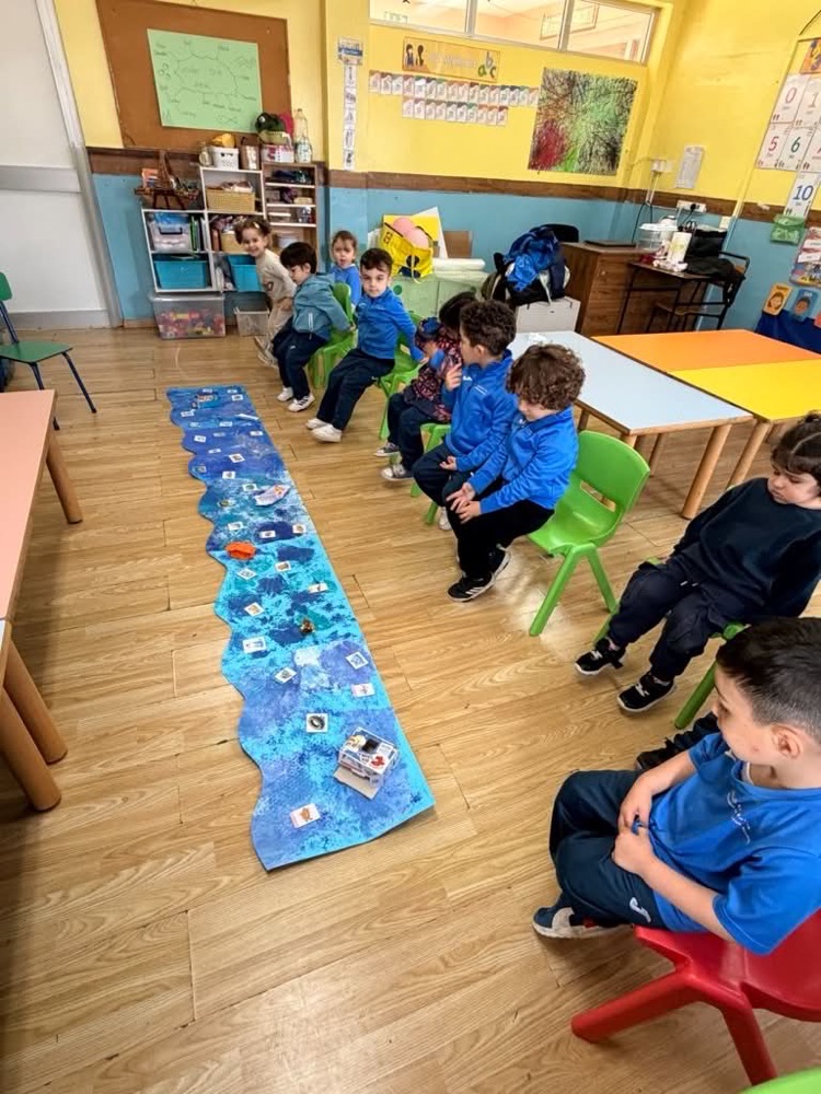 Children working on an ocean-themed floor display in a classroom