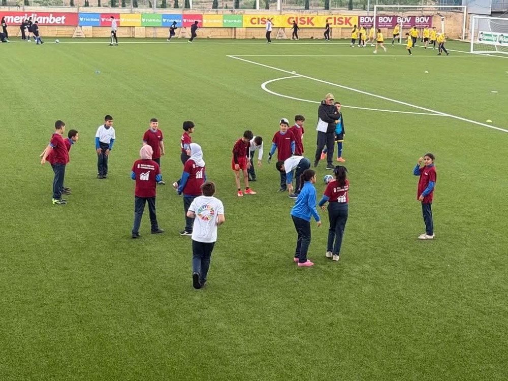 Pupils playing games on a football pitch
